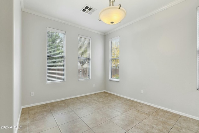 unfurnished room with light tile patterned floors, baseboards, visible vents, and crown molding