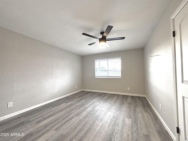 unfurnished room with ceiling fan and dark hardwood / wood-style floors