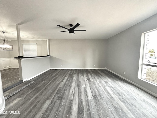 empty room featuring dark wood-type flooring and ceiling fan