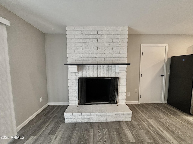 details featuring hardwood / wood-style floors and a brick fireplace