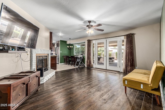 8620 E Sells Dr, Scottsdale, AZ 85251 - living area featuring a brick fireplace, wood finished floors, a ceiling fan, and french doors