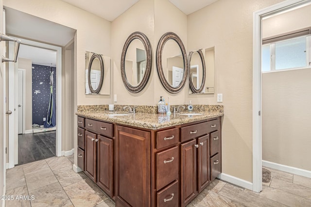 8620 E Sells Dr, Scottsdale, AZ 85251 - bathroom featuring double vanity and baseboards