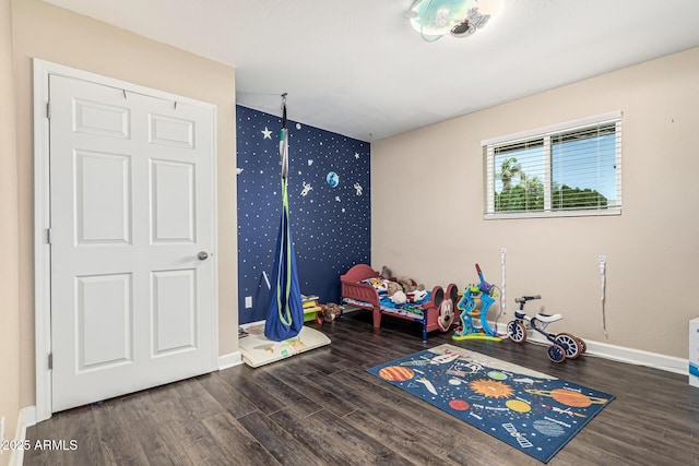 8620 E Sells Dr, Scottsdale, AZ 85251 - game room featuring wallpapered walls, wood finished floors, and an accent wall