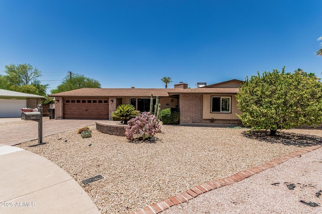 8620 E Sells Dr, Scottsdale, AZ 85251 - single story home featuring brick siding, a garage, a chimney, and driveway