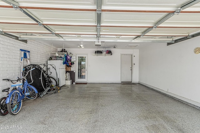 8620 E Sells Dr, Scottsdale, AZ 85251 - garage featuring a garage door opener and freestanding refrigerator