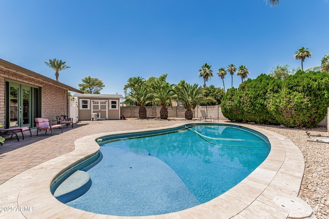 8620 E Sells Dr, Scottsdale, AZ 85251 - view of pool with a patio, a storage unit, and a fenced backyard