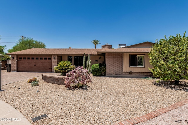 8620 E Sells Dr, Scottsdale, AZ 85251 - single story home featuring brick siding, a chimney, a garage, and driveway