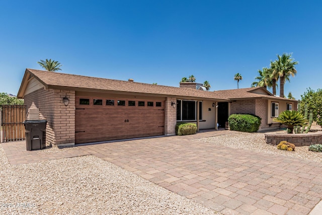 8620 E Sells Dr, Scottsdale, AZ 85251 - ranch-style house featuring an attached garage, brick siding, and decorative driveway