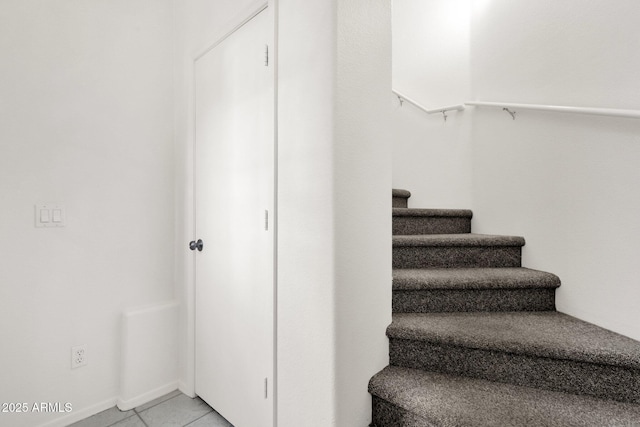 stairs with tile patterned floors