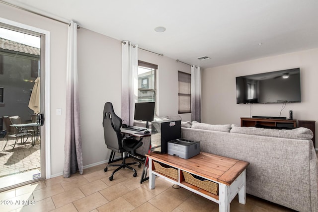 home office with light tile patterned floors, baseboards, and visible vents