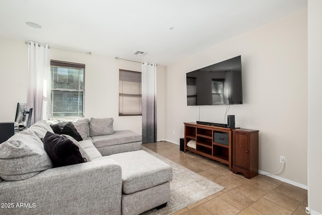 living room with visible vents, baseboards, and light tile patterned flooring