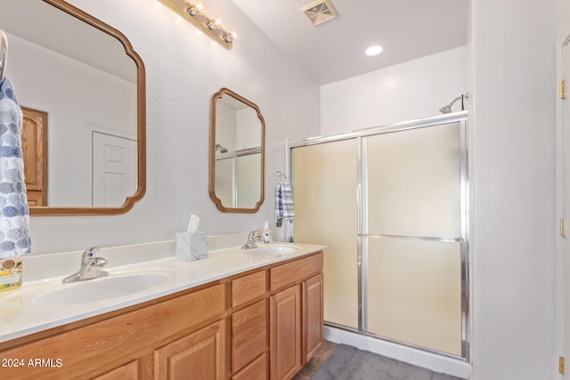 bathroom featuring vanity and an enclosed shower