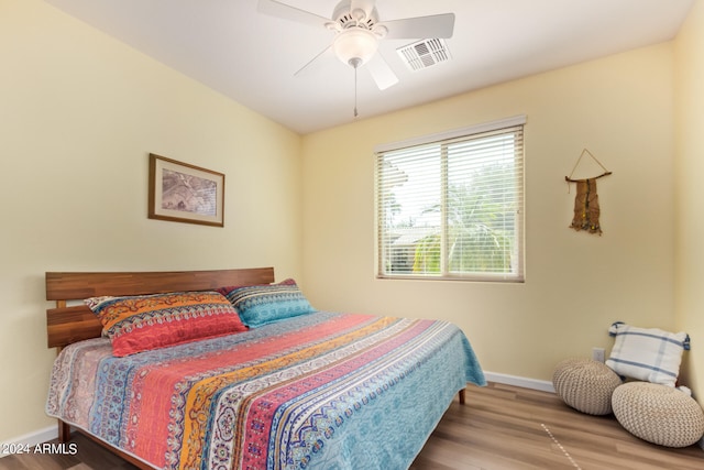 bedroom with hardwood / wood-style flooring and ceiling fan