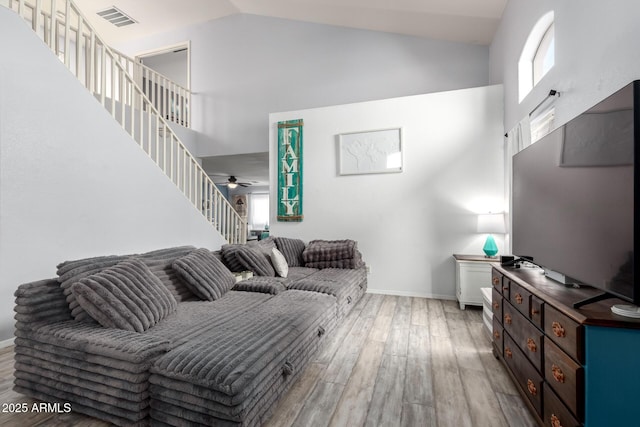 4034 E Mine Shaft Rd, San Tan Valley, AZ 85143 - living area featuring high vaulted ceiling, light wood-style flooring, baseboards, stairway, and ceiling fan