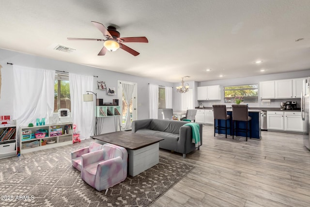 4034 E Mine Shaft Rd, San Tan Valley, AZ 85143 - living area with a chandelier, plenty of natural light, ceiling fan, light wood-style floors, and recessed lighting