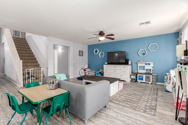 4034 E Mine Shaft Rd, San Tan Valley, AZ 85143 - living area featuring ceiling fan, light wood finished floors, stairway, and baseboards