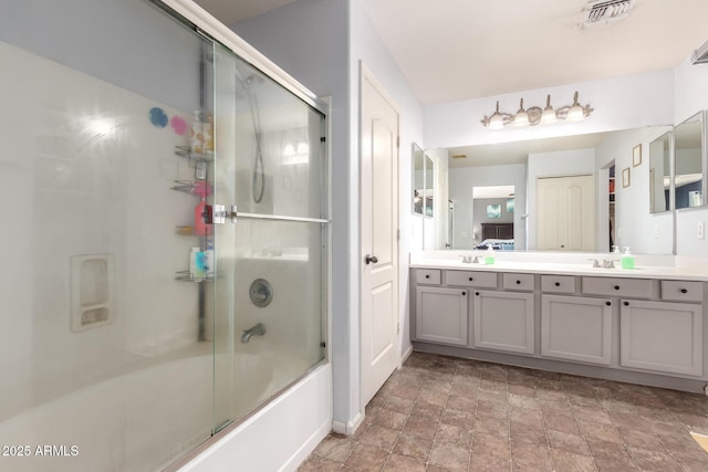 4034 E Mine Shaft Rd, San Tan Valley, AZ 85143 - full bath with double vanity, shower / bath combination with glass door, and stone finish flooring