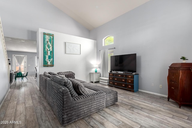 4034 E Mine Shaft Rd, San Tan Valley, AZ 85143 - living room with wood finished floors, high vaulted ceiling, and baseboards