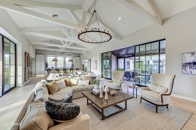 living room with beam ceiling, light hardwood / wood-style flooring, high vaulted ceiling, and an inviting chandelier