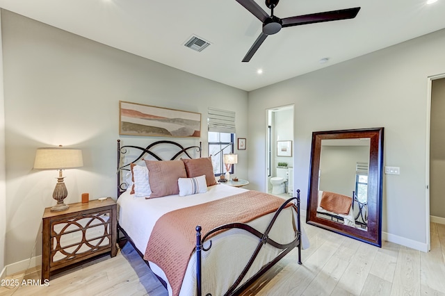 bedroom featuring connected bathroom, light hardwood / wood-style flooring, and ceiling fan