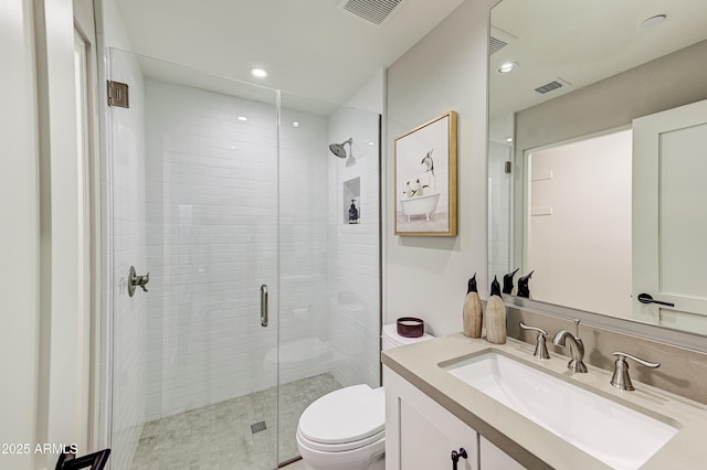 bathroom featuring vanity, toilet, and walk in shower