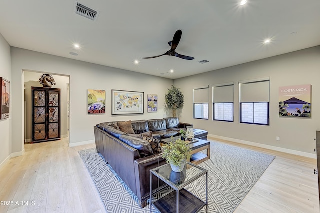 living room with ceiling fan and light wood-type flooring