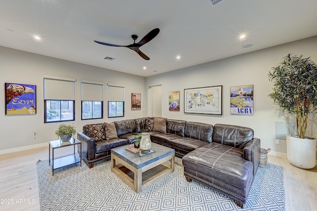 living room featuring ceiling fan and light wood-type flooring