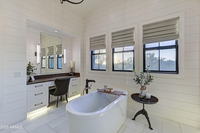 bathroom with a bathing tub, wood walls, tile patterned flooring, and lofted ceiling