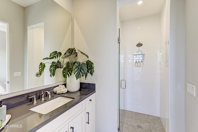 bathroom with vanity and walk in shower