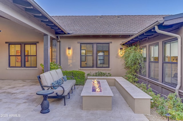 view of patio / terrace featuring an outdoor living space with a fire pit