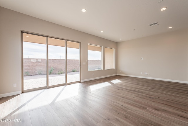 unfurnished room with hardwood / wood-style floors