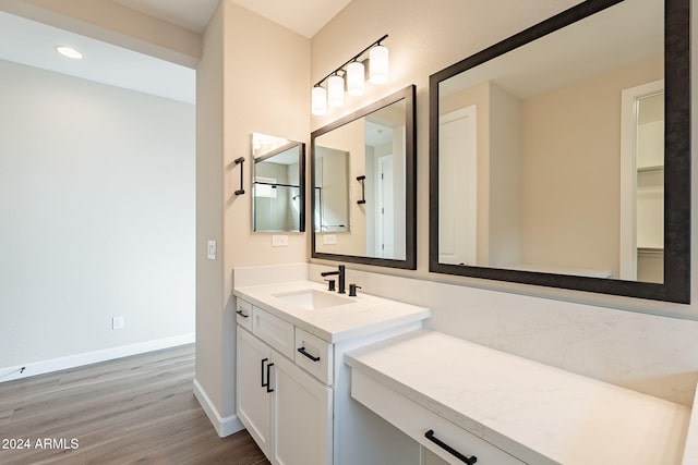 bathroom with hardwood / wood-style floors and vanity