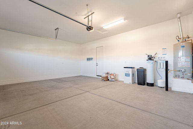 garage featuring a garage door opener and water heater