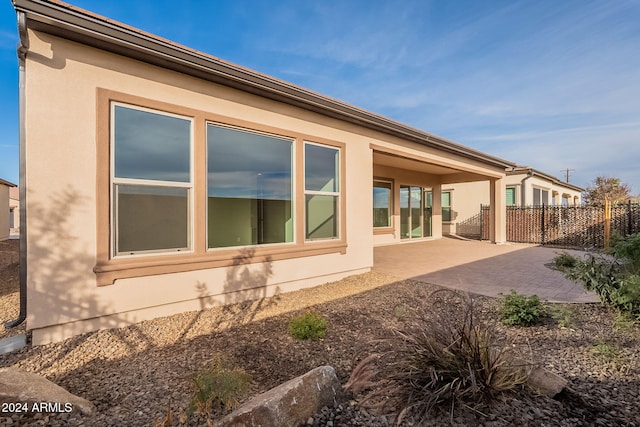 view of property exterior with a patio area