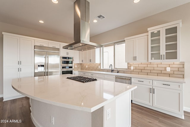 kitchen featuring white cabinetry, island range hood, a center island, and appliances with stainless steel finishes