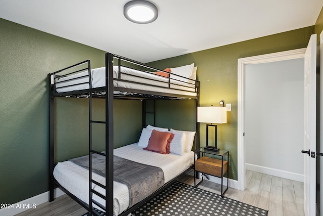 bedroom with wood-type flooring