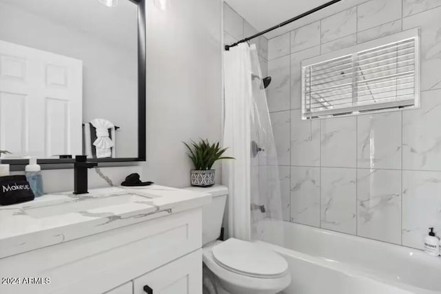 full bathroom with vanity, shower / bath combination with curtain, and toilet