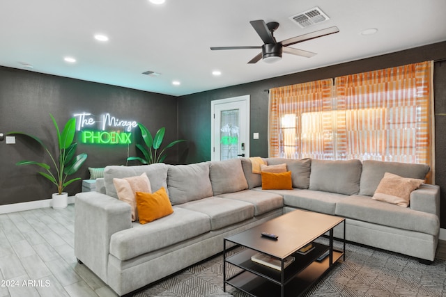 living room featuring hardwood / wood-style flooring and ceiling fan