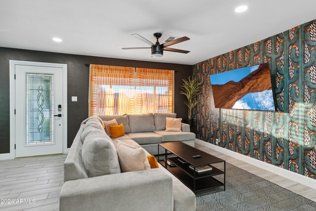 living room with ceiling fan and hardwood / wood-style floors