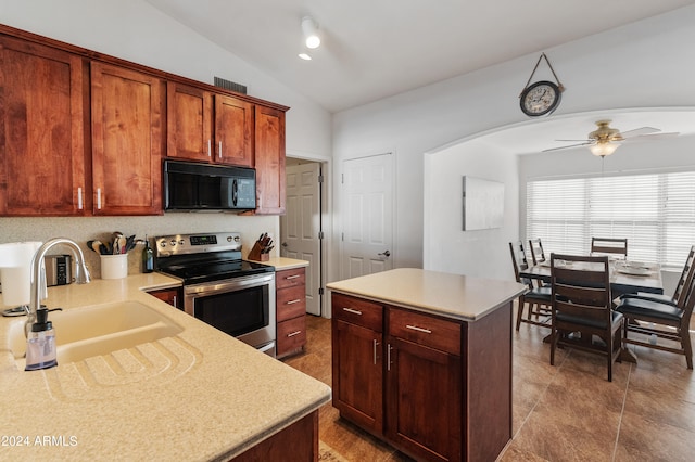 kitchen with lofted ceiling, sink, a center island, stainless steel range with electric cooktop, and ceiling fan