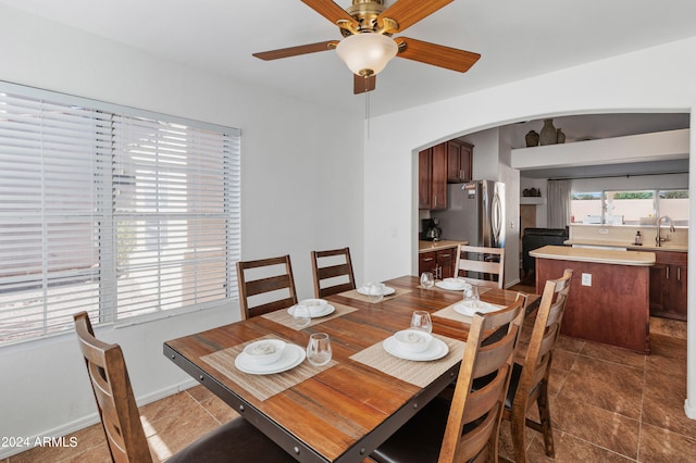 tiled dining room with ceiling fan