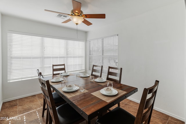 tiled dining area with ceiling fan