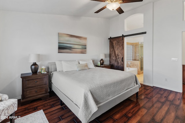 bedroom featuring ensuite bathroom, a barn door, ceiling fan, and dark hardwood / wood-style flooring