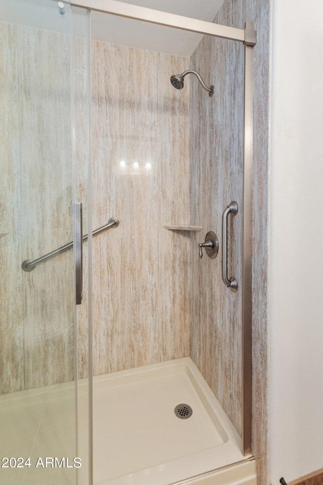 bathroom featuring a shower with door