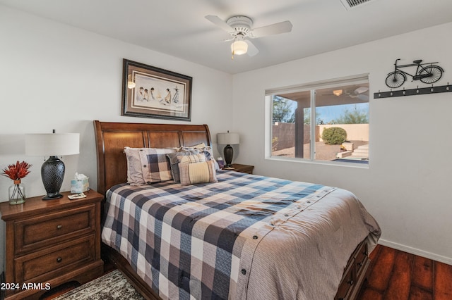 bedroom with dark hardwood / wood-style floors and ceiling fan