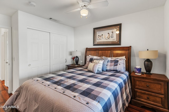 bedroom featuring hardwood / wood-style floors, a closet, and ceiling fan