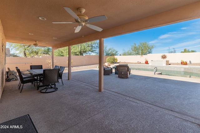 view of patio featuring a fenced in pool and ceiling fan