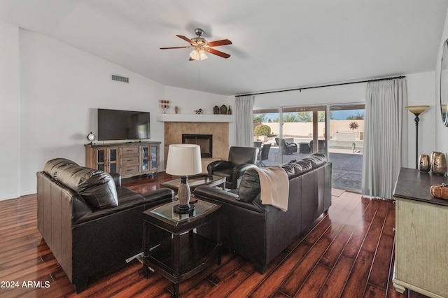 living room featuring dark wood-type flooring, ceiling fan, and vaulted ceiling