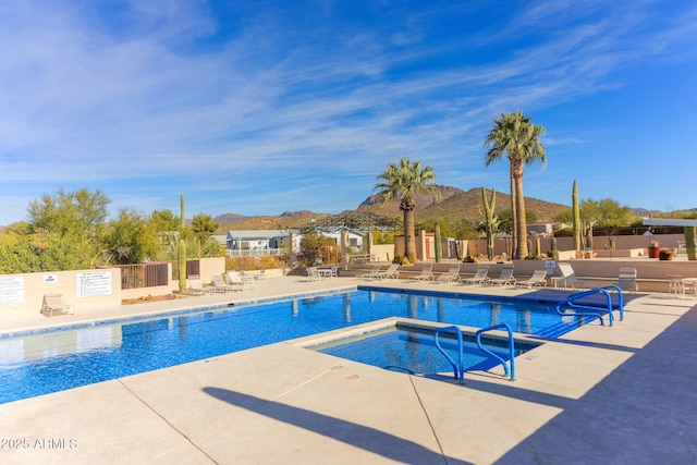 view of pool with a mountain view, a hot tub, and a patio