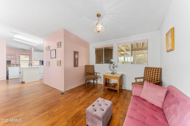 living room with lofted ceiling and hardwood / wood-style flooring